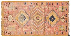 an old rug with many different colors and patterns