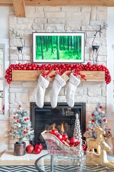 a fireplace decorated for christmas with stockings and ornaments