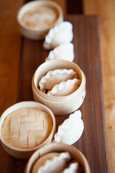 several wooden bowls with food in them sitting on a table