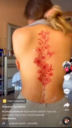 the back of a woman's body with red flowers on it