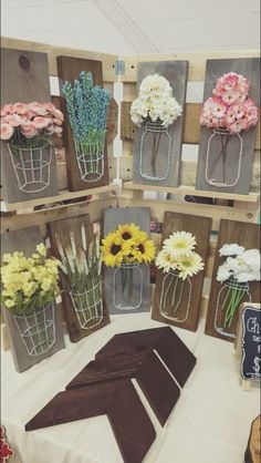 flowers are arranged in mason jars on display