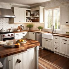 a kitchen with white cabinets and wooden counter tops, along with an island in the middle