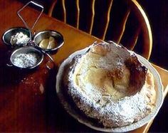 a wooden table topped with a cake covered in icing