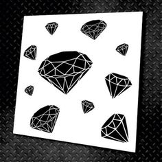 some black and white diamond stickers on a piece of paper