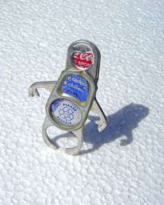 a bottle opener sitting on top of a snow covered ground