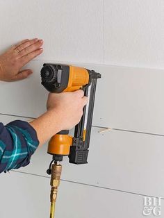 a man is drilling the wall with a drill