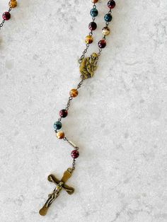 Elevate your prayer time with our Blessed Solanus Casey Commemorative Rosary, a uniquely crafted devotional item paying tribute to the life and virtues of the revered Capuchin friar. This rosary is not just a spiritual tool, but also a symbol of faith, humility, and generosity – the hallmarks of Blessed Solanus Casey's life. Each rosary is meticulously handcrafted in Italy, featuring superior quality solid 8mm Bohemian Glass beads in a serene blue, rust and brown color, reminiscent of the Capuch Adjustable Spiritual Rosary With Miraculous Medal, Spiritual Crucifix Rosary For Blessing, Handmade Spiritual Rosary, Adjustable Spiritual Rosary As Gift, Adjustable Brown Spiritual Rosary, Solanus Casey, Catholic Candles, Catholic Family, Prayer Life