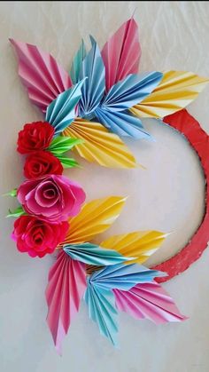 paper flowers are arranged in the shape of a wreath