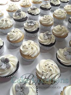 cupcakes with white frosting and silver decorations