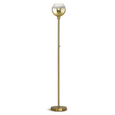 a gold floor lamp with a glass shade on the top and an oval light fixture at the bottom