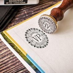 a rubber stamp sitting on top of a piece of paper next to a wooden handle