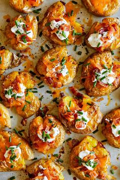 baked potatoes with cheese and herbs on a sheet of parchment paper, ready to be eaten