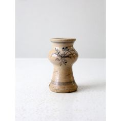 a small vase sitting on top of a white table