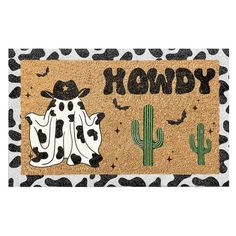 a door mat with the words hondy and two cows in front of cacti