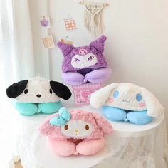 three stuffed animals sitting on top of a table