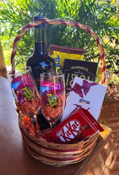 a basket filled with drinks and snacks on top of a table