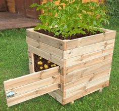 a planter made out of wooden pallets with plants growing in the bottom half