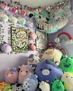 many stuffed animals are arranged on the wall