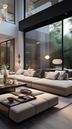 a modern living room with large windows and white couches