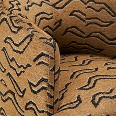 an upholstered chair with black and tan patterns