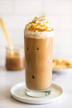 there is a drink with whipped cream on the top and caramel in the bottom