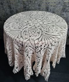 a round table with white doily on it