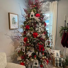 a christmas tree decorated with red and silver ornaments