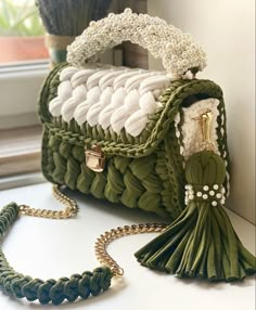 a green purse sitting on top of a table