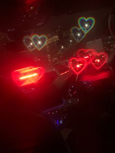 two heart shaped lights on the dashboard of a car