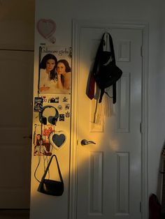 the door is open and there are headphones hanging on the wall next to it