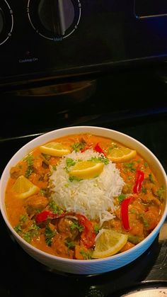 a white bowl filled with food on top of a stove