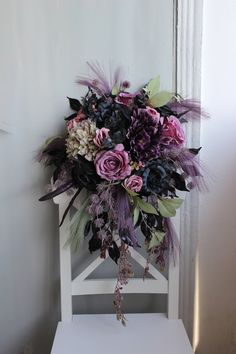 a bouquet of flowers sitting on top of a white chair