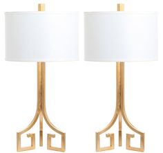 pair of gold table lamps with white shades on each lamp and one light in the middle