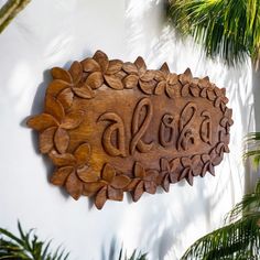 a wooden sign on the side of a building that says sold and decorated with flowers