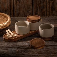 three cups and spoons on a wooden table