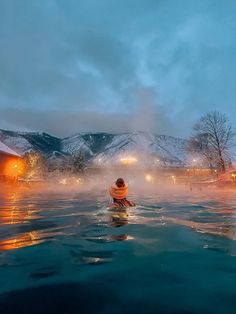 a person sitting in the middle of a body of water