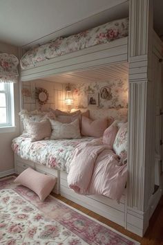 a white bunk bed with pink flowers on the sheets and pillows, along with matching rugs