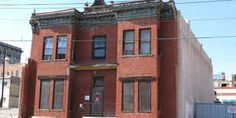 an old red brick building with many windows