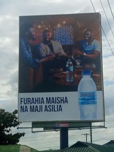 an advertisement for bottled water on a billboard