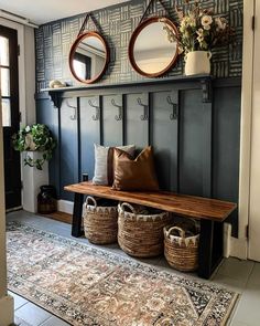 a bench with baskets and mirrors on the wall