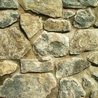 a stone wall made out of rocks with no mortar or mortars on the side