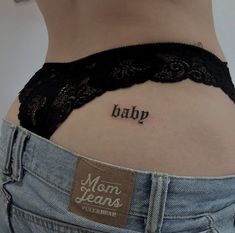 a woman's lower back tattoo with the word baby tattooed on her left side