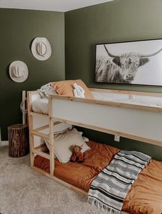 a bunk bed with an animal painting on the wall