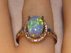 Solid 14k Yellow Gold Ring with one Natural Opal surrounded by natural diamonds. This Black Opal is from Lightning Ridge , Australia. It is 100% Natural and not a doublet or triplet. Please Note: The opal is not set as of yet.  Prongs will be filed down to size and the Opal will be set once I know your ring size. Regards Jason GOLD WEIGHT: 3.1 grams Solid 14k Yellow Gold OPAL SIZE:  10.3 x 7.2 x 3.8 mm OPAL WEIGHT :   2.0 ct. COLORS:     Green and Gold PATTERN:    banded / confetti   BRIGHTNESS: Luxury Polished Opal Ring Fine Jewelry, Black Opal Fine Jewelry, Weird Accessories, Black Opal Jewelry, Opal And Diamond Ring, Opal Diamond Ring, Black Opal Stone, Black Opal Ring, Flawless Diamond