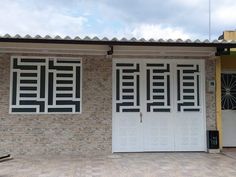 two white doors are open in front of a brick building