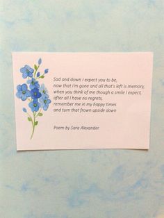 a piece of paper with blue flowers on it and a poem written in the center