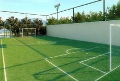 a soccer field with a goal and ball on it