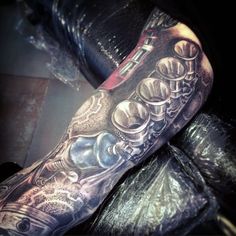 a man's arm with tattoos on it and his leg is covered in buttons