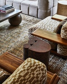 a living room filled with lots of furniture next to a couch and coffee table on top of a rug