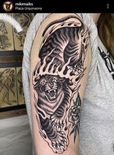 a woman with a tiger tattoo on her arm